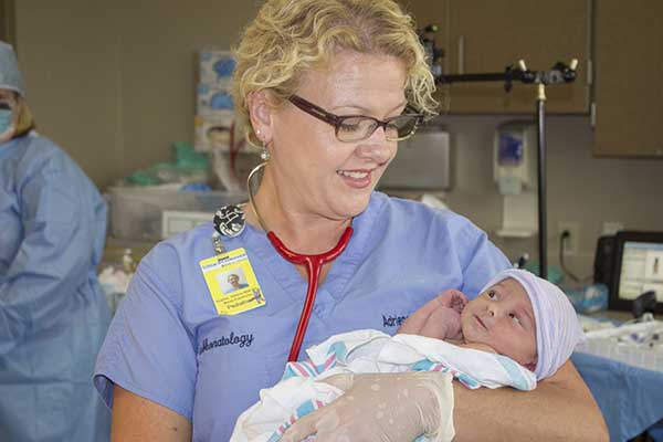 Image of a nurse with a newborn baby