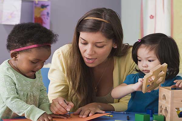 Image of a teacher with two children